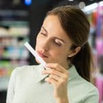 brunette woman smelling perfume