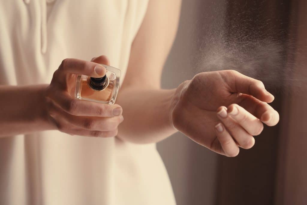 woman spraying perfume