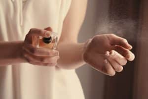 woman spraying perfume