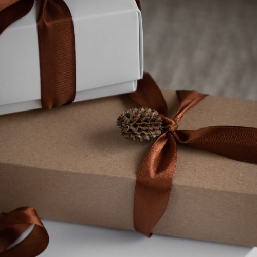 natural brown and white christmas gifts with brown silk ribbon and pine cone decoration